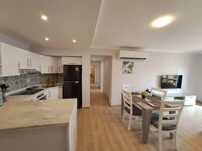 a kitchen and dining room with a table and chairs at Tawaya Sea View 2 bedrooms in Hurghada