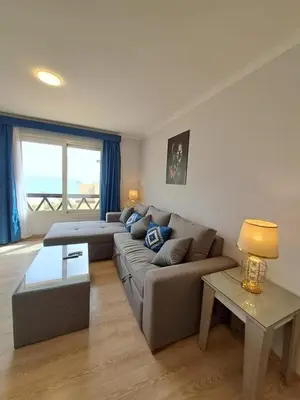 a living room with a couch and a table at Tawaya Sea View 2 bedrooms in Hurghada
