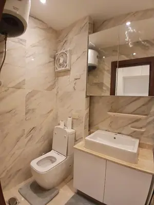 a bathroom with a toilet and a sink and a mirror at Luxury Newly Built 2 DOUBLE bedroom and living room with Beach Access and Pool in Hurghada, Egypt in Hurghada