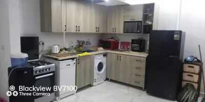 a kitchen with a refrigerator and a stove and a dishwasher at Fanadir Bay Elnoras213 Hurghada in Hurghada