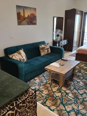 a living room with a blue couch and a coffee table at Hurhgada concierge at Turtles beach resort in Hurghada