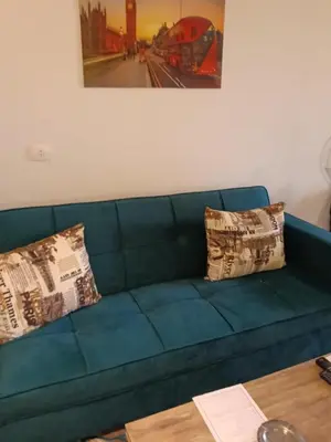 a blue couch with two pillows on it at Hurhgada concierge at Turtles beach resort in Hurghada