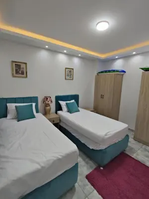 two beds in a room with twoermottermott at Oasis Resort Compound in Hurghada