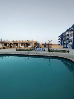 a pool of water in front of a building at Oasis Resort Compound in Hurghada