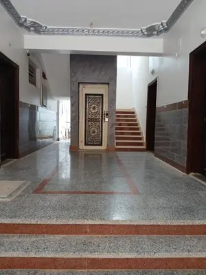 a hallway with a door and stairs in a building at Essa Apartment in Safaga