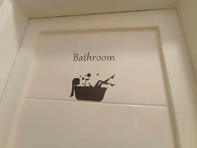 a shelf with a bathroom sign on the wall at Oasis marina الاحياء in Hurghada