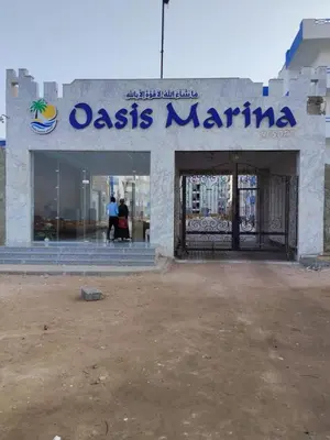 a building with a sign that reads oasis marina at Oasis marina الاحياء in Hurghada