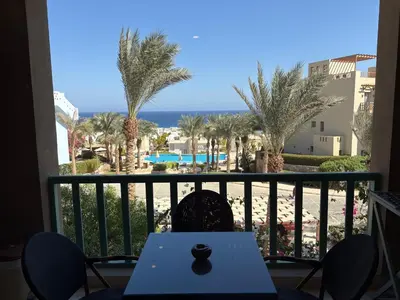 a view of the beach from the balcony of a resort at Azzurra Sea&pool View 2Bedrooms in Hurghada