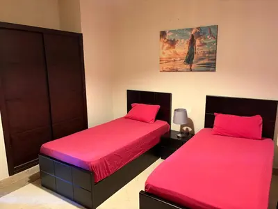two beds sitting next to each other in a room at Azzurra Sea&pool View 2Bedrooms in Hurghada