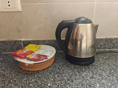 a tea kettle sitting on a counter next to a coaster at Bayt Hassan S2 - Cosy 1 bedroom apartment in Hurghada