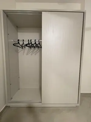 a closet with white doors and hangers at Bayt Hassan S2 - Cosy 1 bedroom apartment in Hurghada