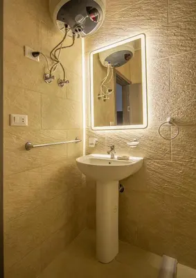 a bathroom with a sink and a mirror at Bayt Hassan S2 - Cosy 1 bedroom apartment in Hurghada