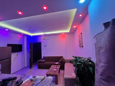 a living room with purple and red lights on the ceiling at Elegant Stay Apartment in Hurghada