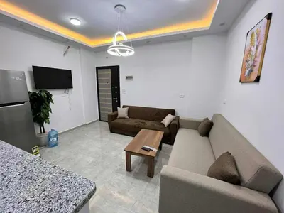 a living room with a couch and a table at Elegant Stay Apartment in Hurghada