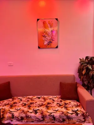 a table in a room with a painting on the wall at Elegant Stay Apartment in Hurghada