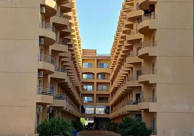 a large building with balconies on the side of it at Fiesta Beach Resort in Hurghada