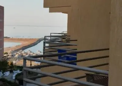 a balcony with a view of the ocean and a beach at Fiesta Beach Resort in Hurghada