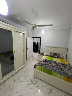 a bedroom with a bed and a mirror at شقة فندقية صف أول بحر وبول in Hurghada