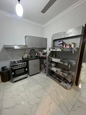 a kitchen with a stove and an open refrigerator at شقة فندقية صف أول بحر وبول in Hurghada