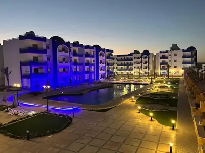 a large courtyard with a pool in front of some buildings at شقة فندقية صف أول بحر وبول in Hurghada