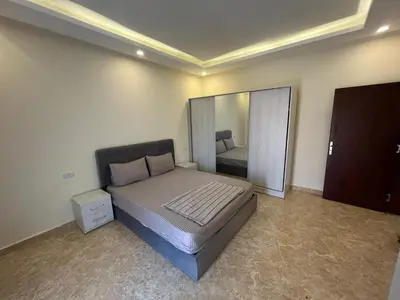 a bedroom with a bed and a large mirror at Mirage Bay Apartments in Hurghada