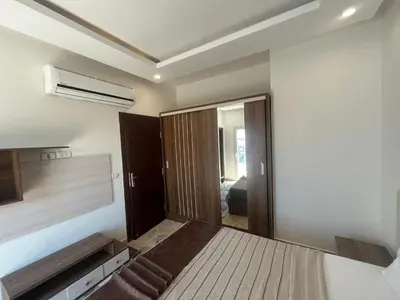 a bedroom with a bed and a tv and a mirror at Mirage Bay Apartments in Hurghada