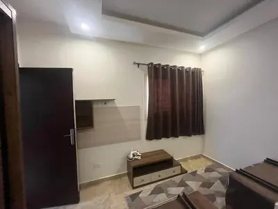 a room with a door and a window and a table at Mirage Bay Apartments in Hurghada