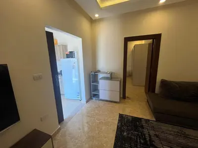 a living room with a refrigerator and a living room at Mirage Bay Apartments in Hurghada