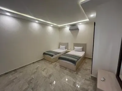 a small room with two beds in it at Mirage Bay Apartments in Hurghada