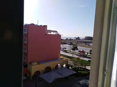a view from a window of a building with an umbrella at Hurghada El marina in Hurghada