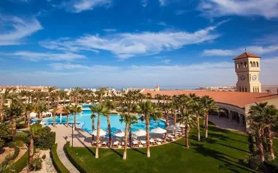 an aerial view of a resort with a pool and a clock tower at Luxurious Cozy studio in Sahl Hasheesh Hurghada in Hurghada