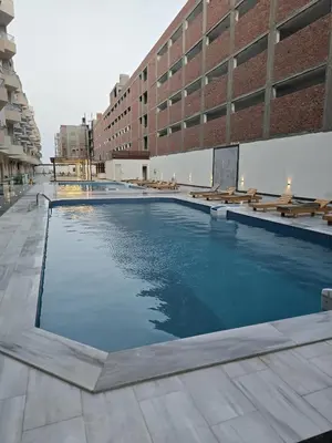 a swimming pool in the middle of a building at Nada C206 in Hurghada