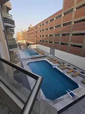 a swimming pool on the roof of a building at Nada C206 in Hurghada