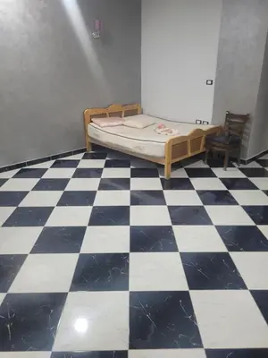 a bedroom with a bed and a checkered floor at Hurghada down town in Hurghada