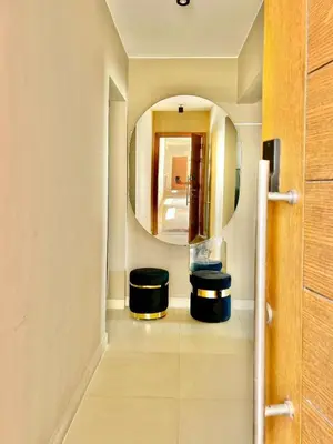 a bathroom with two stools and a mirror at Sea View Serenity - Stylish 2BR Retreat in Hurghada