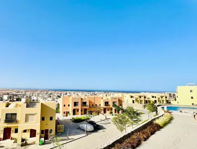 an aerial view of a resort with a beach and buildings at Sea View Serenity - Stylish 2BR Retreat in Hurghada