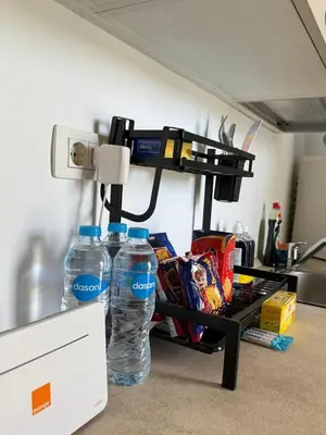 two bottles of water on a shelf in a kitchen at Cozy 2BR with pool access in Hurghada