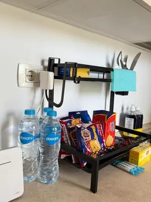 a shelf with two bottles of water and snacks at Cozy 2BR with pool access in Hurghada