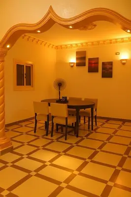 a dining room with a table and chairs at Casa De Amor in Abu Dabab