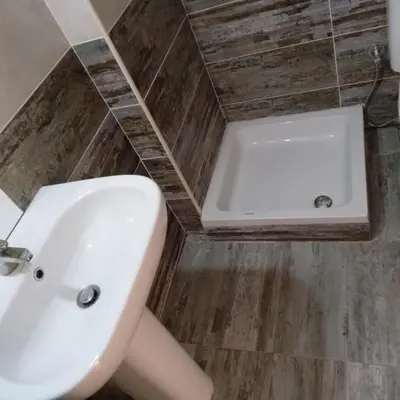 a bathroom with a white sink and a tub at George Villa in Hurghada