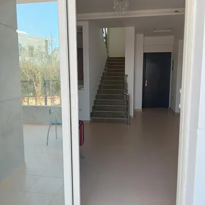 a hallway with stairs and a chair in a building at George Villa in Hurghada
