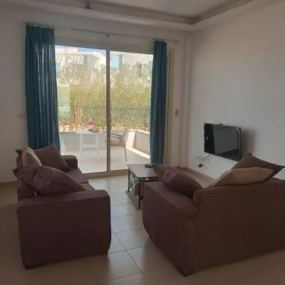 a living room with two couches and a television at George Villa in Hurghada