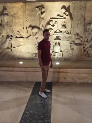 a man standing in front of a sarcophagus at الأقصر الضبعيه in Al Baghdādī