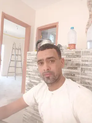 a man sitting in front of a brick wall at الأقصر الضبعيه in Al Baghdādī