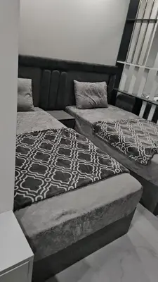 two beds sitting next to each other in a room at Scandic Beach Luxury in Hurghada