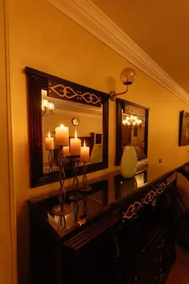 a room with a dresser with a large mirror at Aswan Heritage Residence-Nile View and Free Airport Pickup in Aswan