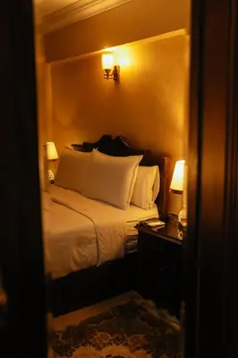 a bedroom with a bed with white pillows at Aswan Heritage Residence-Nile View and Free Airport Pickup in Aswan