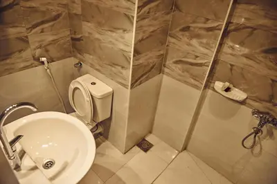 a bathroom with a toilet and a sink at Town Hotel- Hurghada in Hurghada