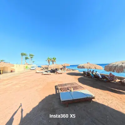 a beach with chairs and umbrellas and the ocean at New chalet with sea view and private beach access 82m in Hurghada
