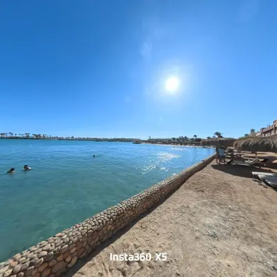 a beach with people swimming in the water at New chalet with sea view and private beach access 82m in Hurghada